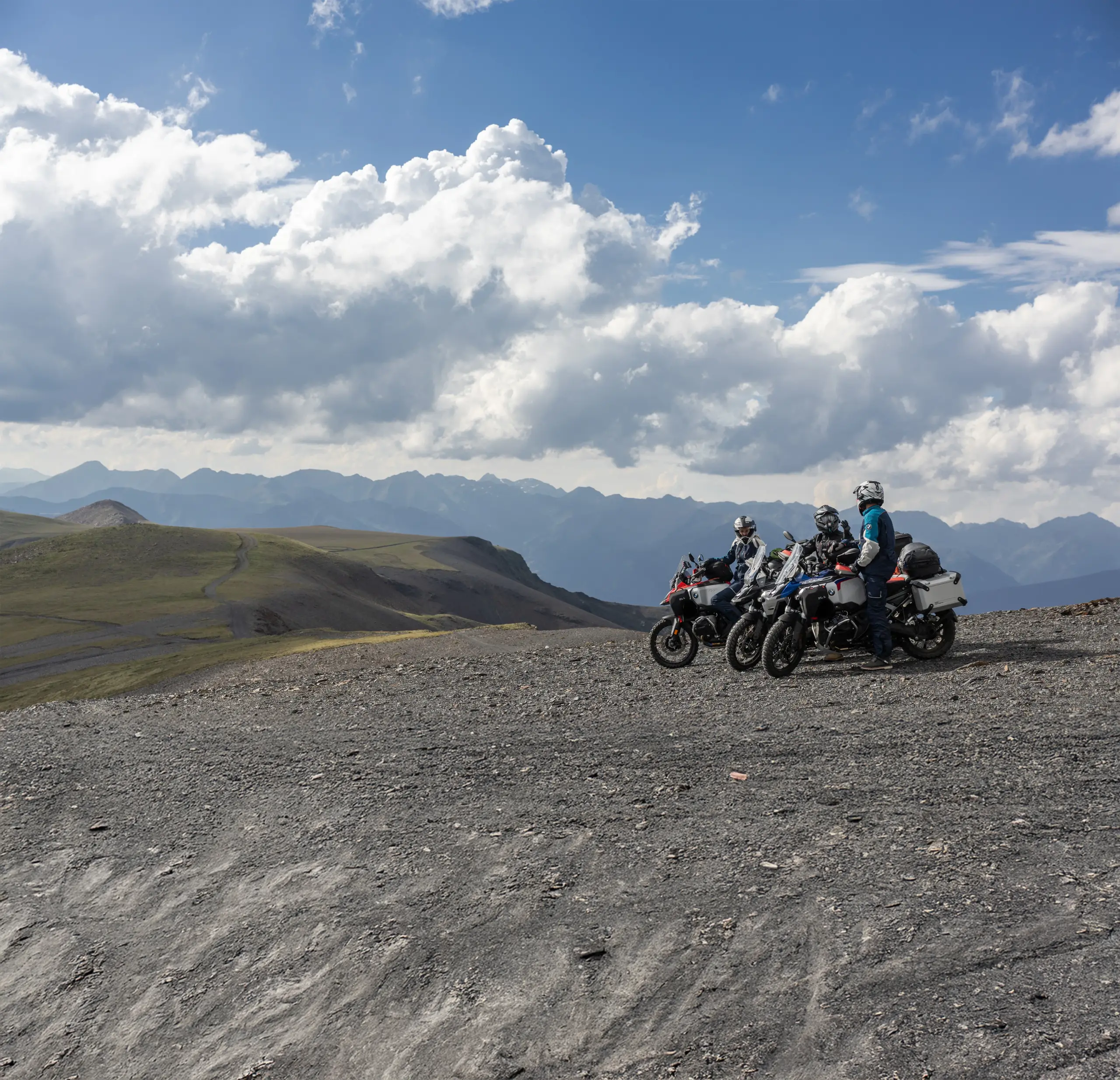 2026 BMW R 1300 GS adventure motorcycle in a lifestyle marketing setting outdoors.